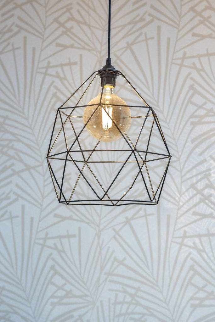 black pendant lamp shade hanging on ceiling vertical shot